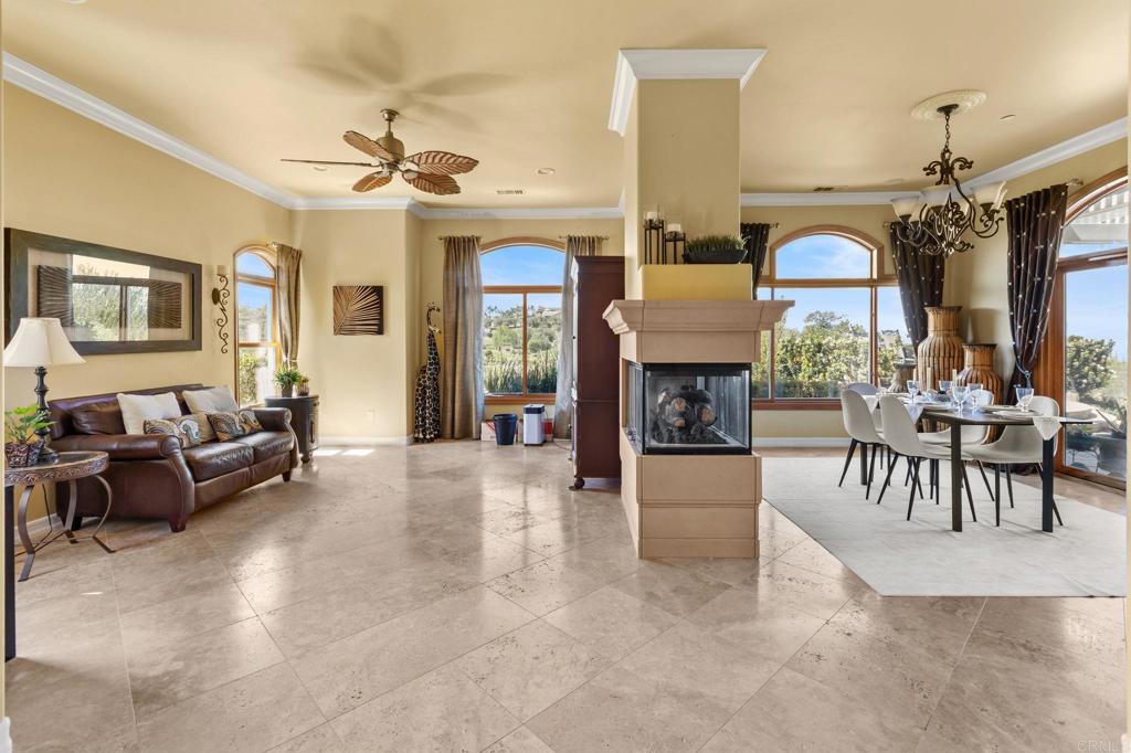 28623 Willow Park Road Escondido, CA 92026 - Photo 19 of 21 a living room with furniture a fireplace and a chandelier