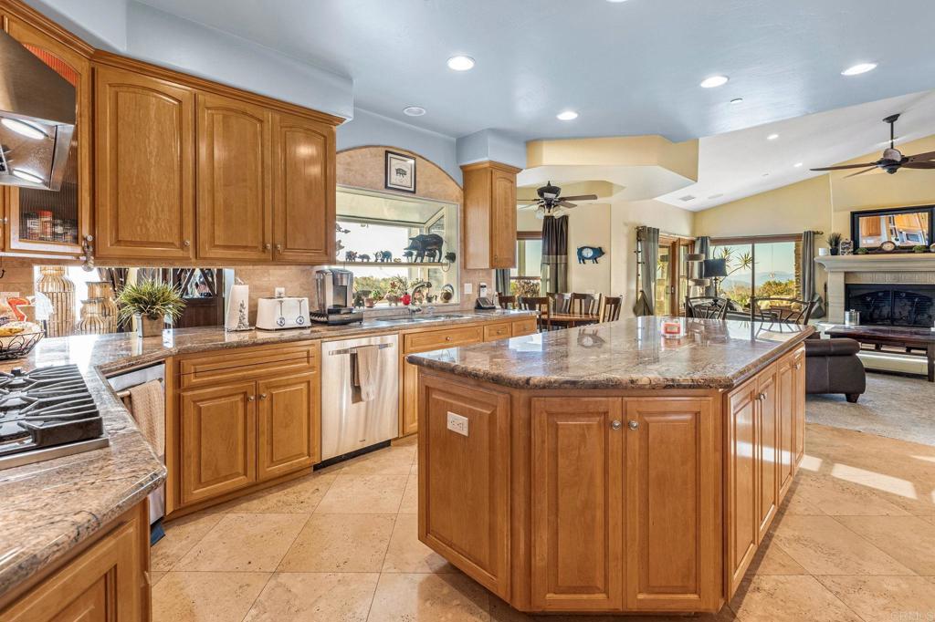 28623 Willow Park Road Escondido, CA 92026 - Photo 4 of 21 a kitchen with stainless steel appliances granite countertop a sink a stove and a refrigerator
