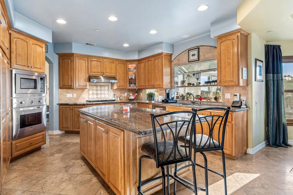 28623 Willow Park Road Escondido, CA 92026 - Photo 6 of 21 a kitchen with stainless steel appliances granite countertop a stove a sink a refrigerator and island