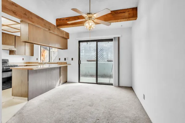 a view of a kitchen with a sink and a refrigerator