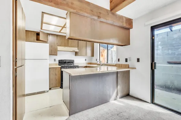 a kitchen with stainless steel appliances granite countertop a refrigerator and a stove
