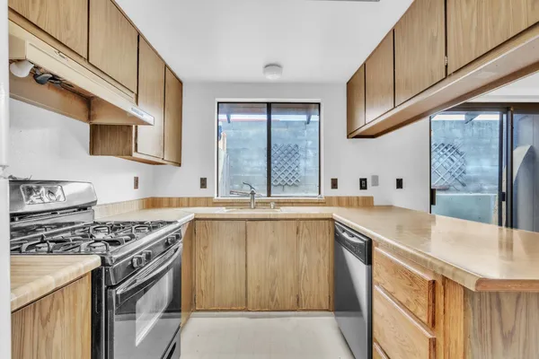 a kitchen that has a sink and a stove