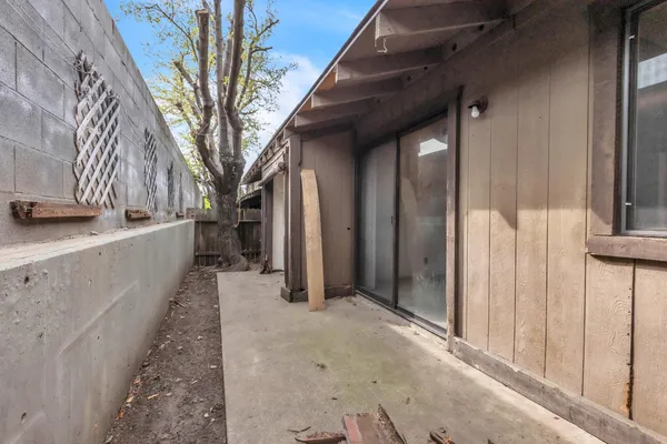 a view of a house with a wooden fence