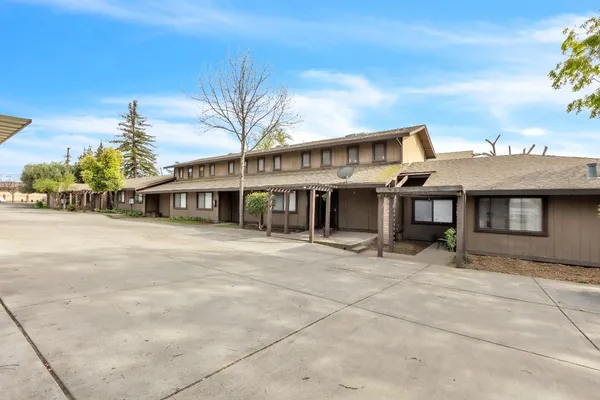 view of a building with a yard and sitting area