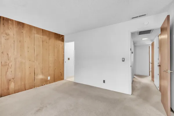 a view of a big room with closet and chandelier fan