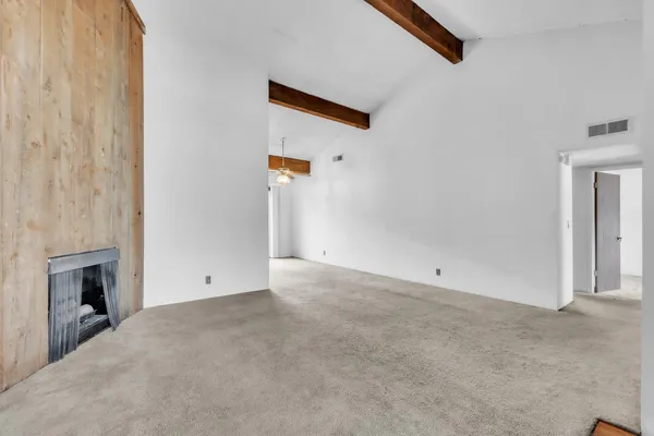 a view of an empty room with a fireplace