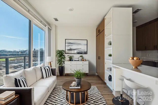 a living room with furniture and a large window