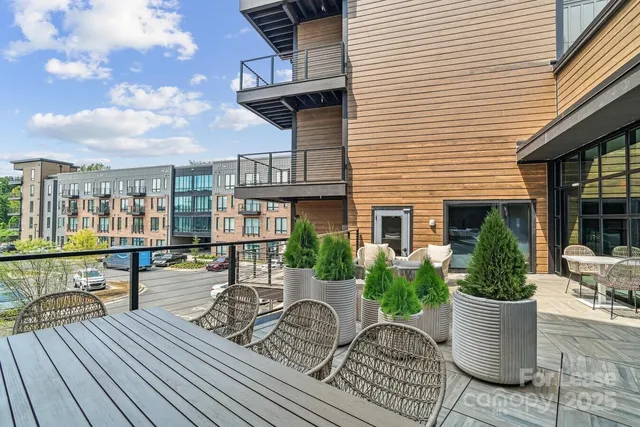a view of house with patio outdoor seating and plants