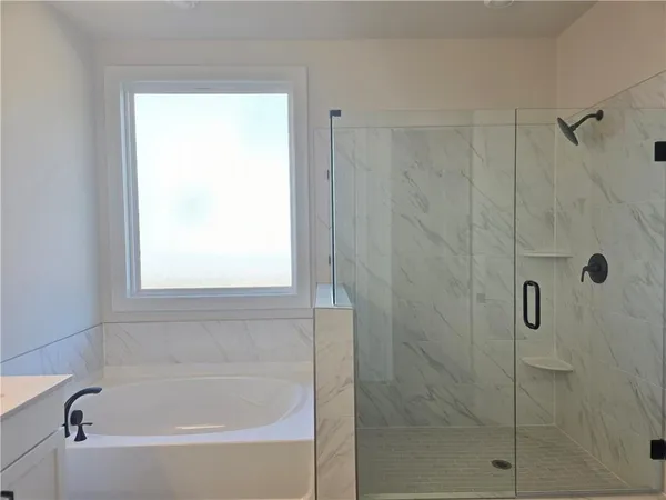 a white bath tub sitting next to a window