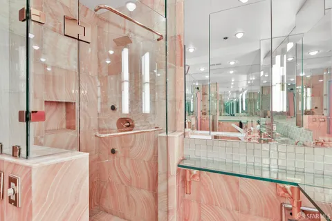 a bathroom with a tub sink and mirror