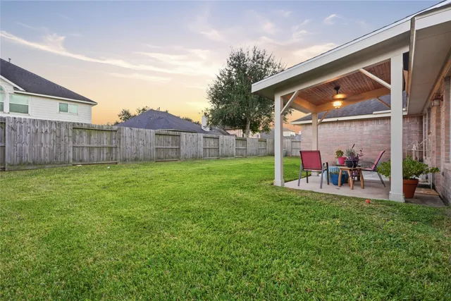 an aerial view of residential houses with outdoor space and river