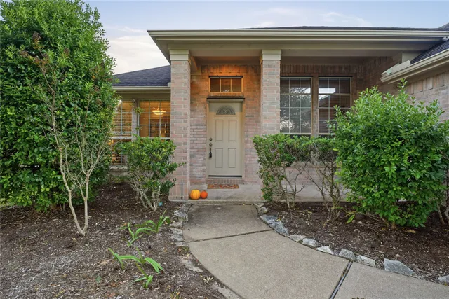 an aerial view of a residential houses with outdoor space and ocean view