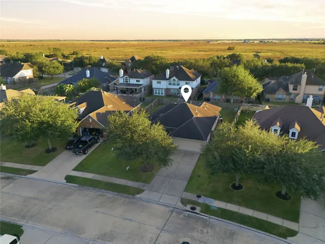 an aerial view of residential houses with outdoor space