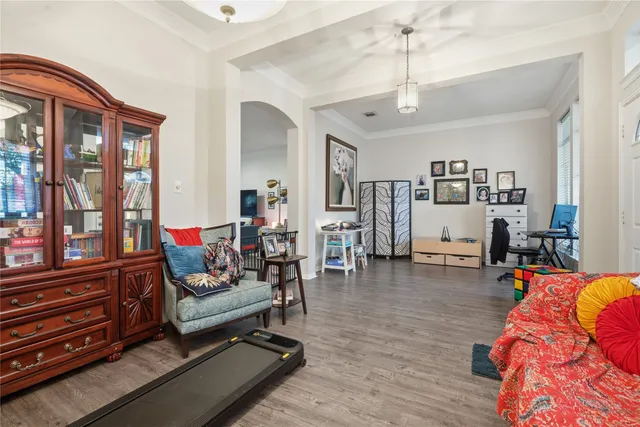 a living room with furniture or wooden floor and a book shelf