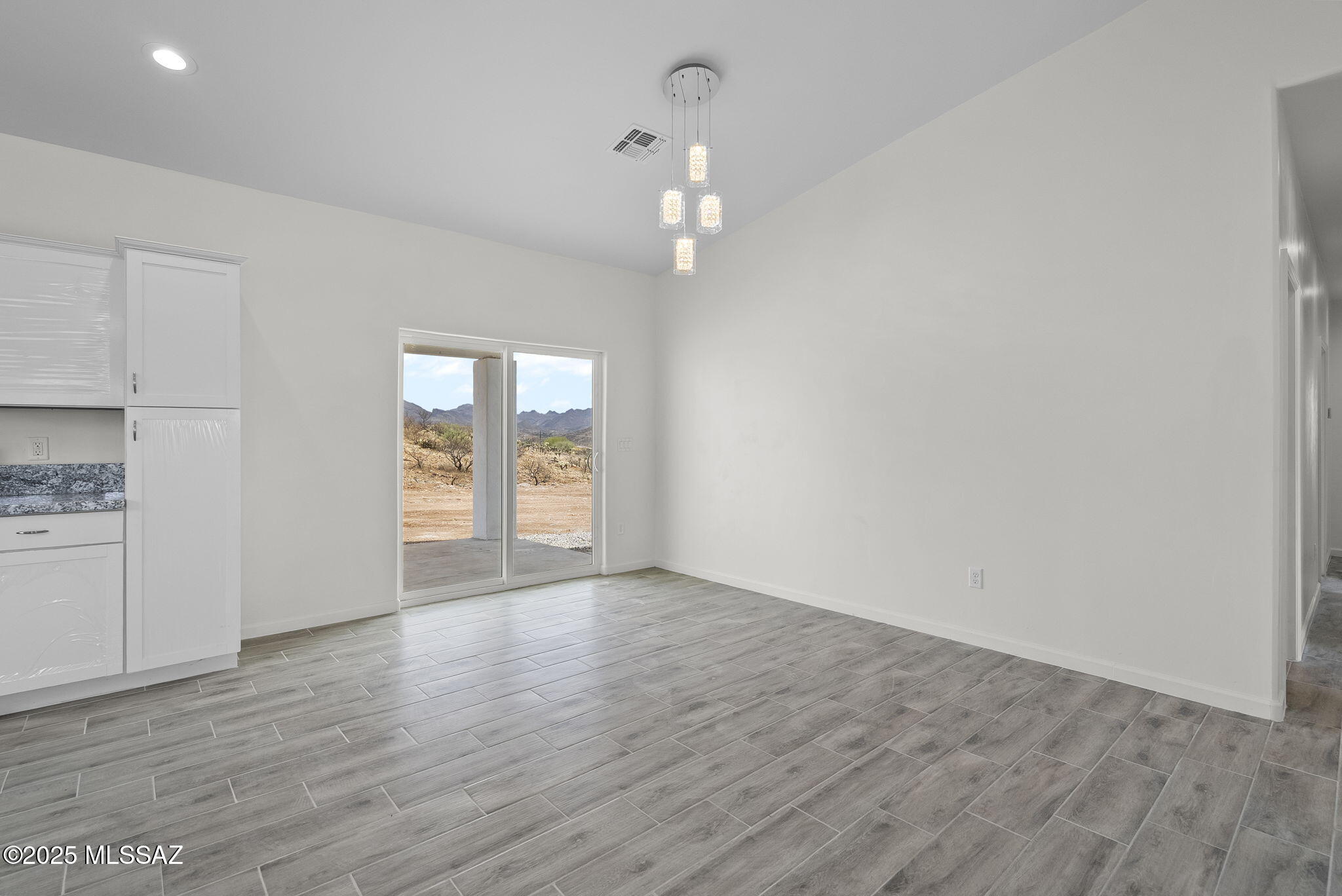 1895 Roma Court Rio Rico, AZ 85648 - Photo 14 of 42 wooden floor in an empty room with a window