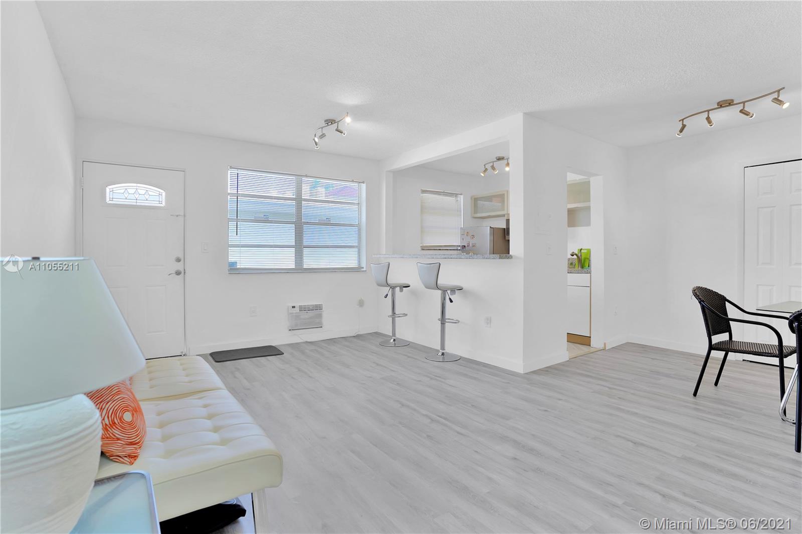 734 Meridian Avenue, Unit 4 Miami Beach, FL 33139 - Photo 2 of 12 a view of empty room with wooden floor and fan