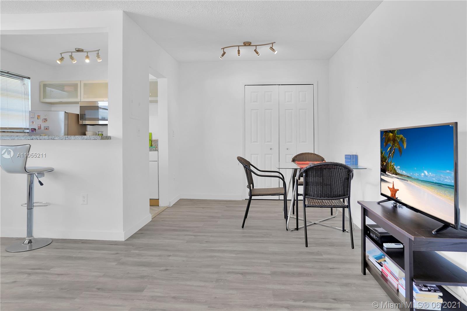 734 Meridian Avenue, Unit 4 Miami Beach, FL 33139 - Photo 3 of 12 a view of a dining room with furniture and wooden floor