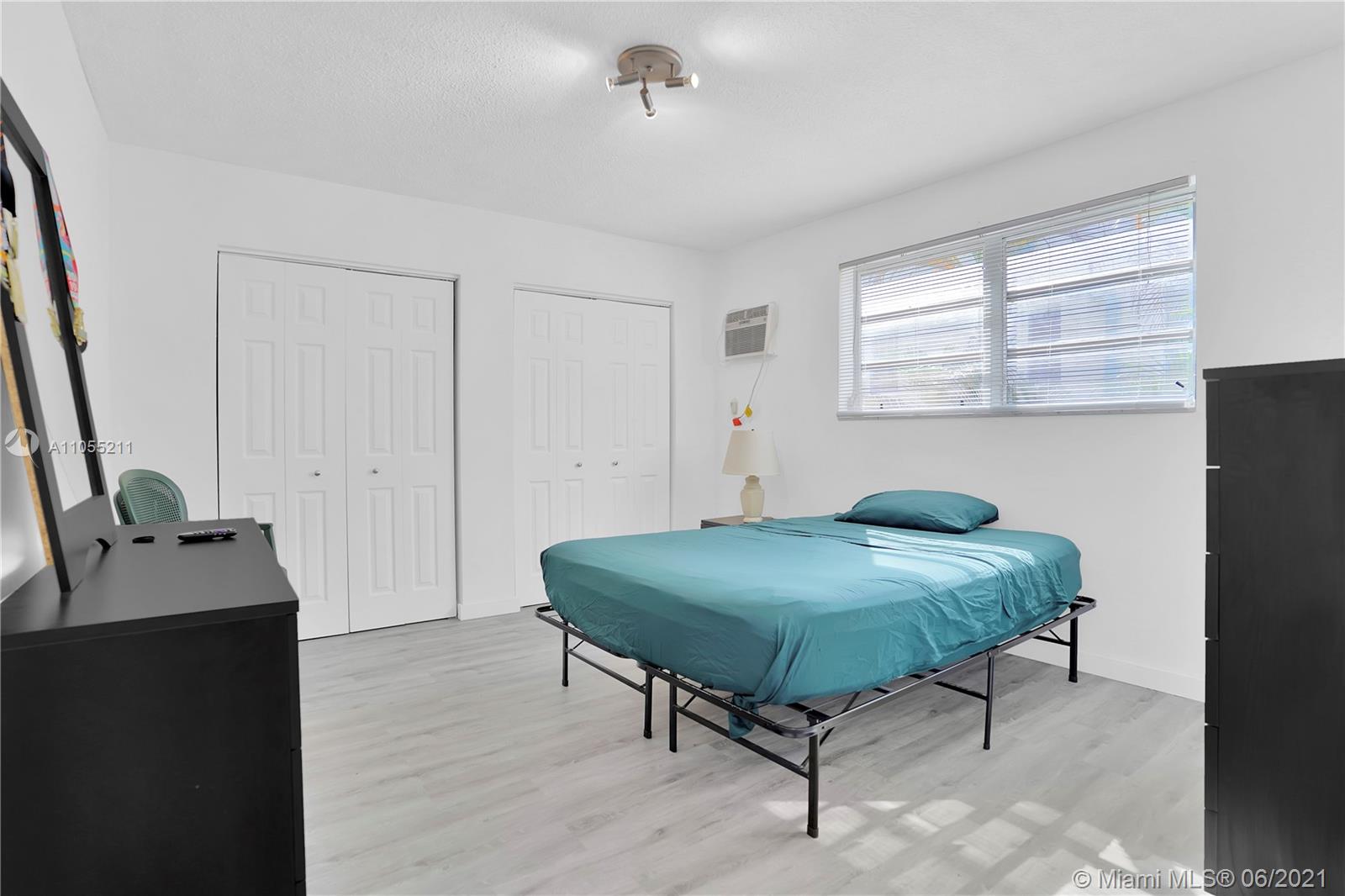 734 Meridian Avenue, Unit 4 Miami Beach, FL 33139 - Photo 5 of 12 a living room with furniture and a window