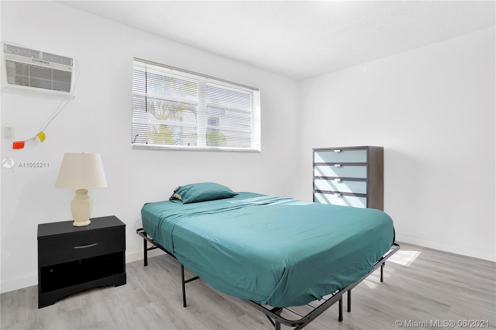 734 Meridian Avenue, Unit 4 Miami Beach, FL 33139 - Photo 6 of 12 a bedroom with a bed and a window