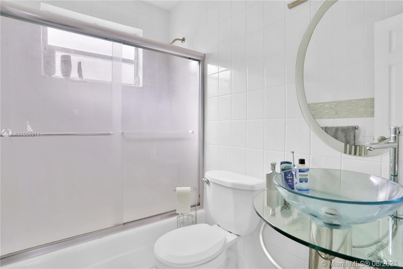 734 Meridian Avenue, Unit 4 Miami Beach, FL 33139 - Photo 7 of 12 a bathroom with a sink a toilet and shower