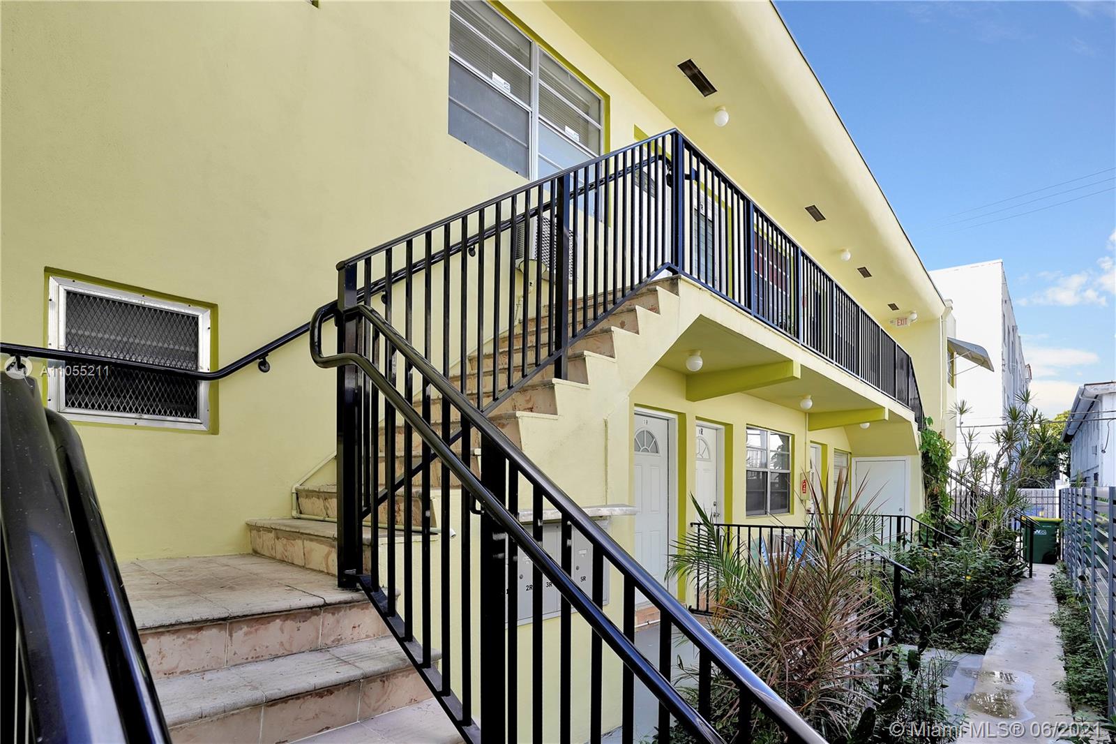 734 Meridian Avenue, Unit 4 Miami Beach, FL 33139 - Photo 10 of 12 a view of staircase with railing and a chandelier