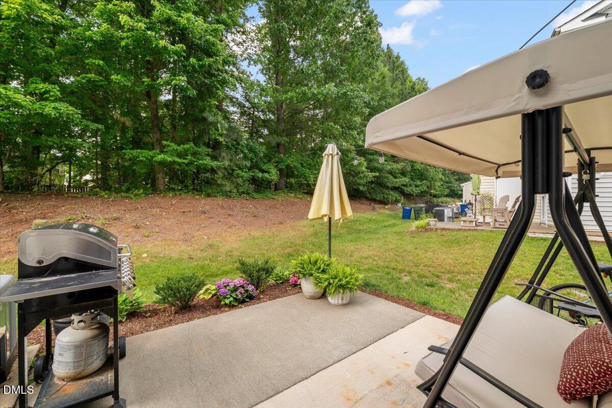8449 Central Drive Raleigh, NC 27613 - Photo 32 of 38 a view of a backyard with plants and a patio