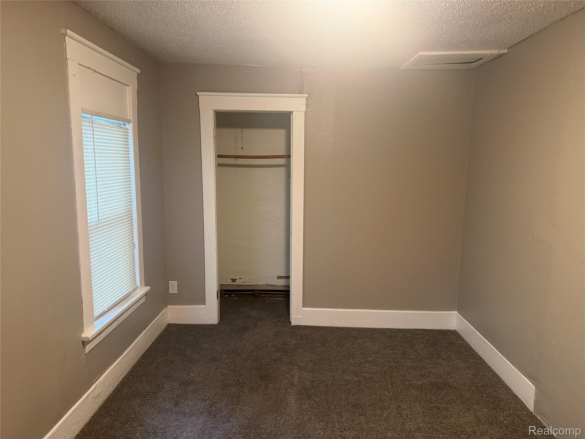 3322 Isabelle Street Inkster, MI 48141 - Photo 8 of 13 Carpeted room with neutral wall paint, white trim, and a window with blinds