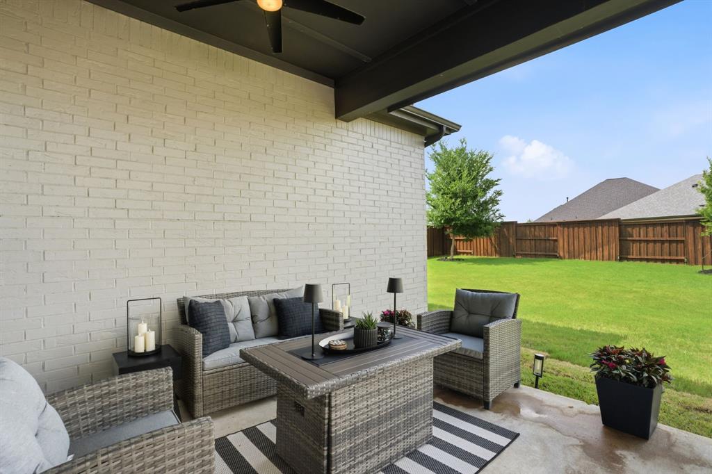 1632 Cotton Road Van Alstyne, TX 75495 - Photo 24 of 40 a view of a patio with couches chairs potted plants and a table