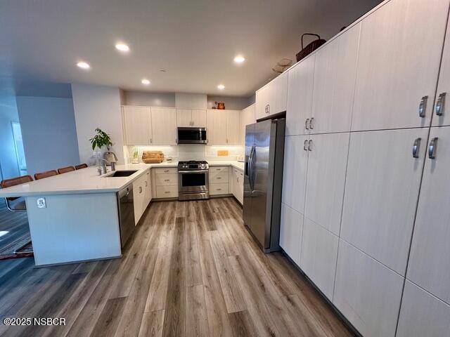0 Old Mission Drive Solvang, CA 93463 - Photo 9 of 68 a kitchen with stainless steel appliances a refrigerator a sink dishwasher a stove and white cabinets with wooden floor