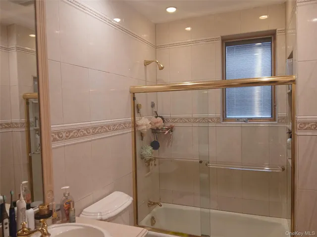 a bathroom with a shower and a mirror