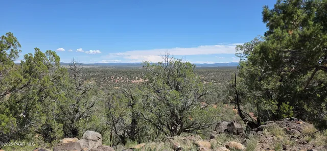 a view of mountain with sunset in background