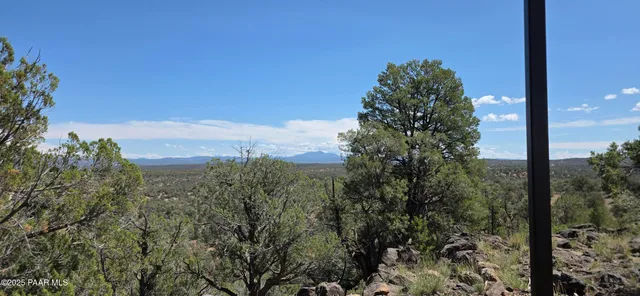 a view of balcony with wooden floor and fence