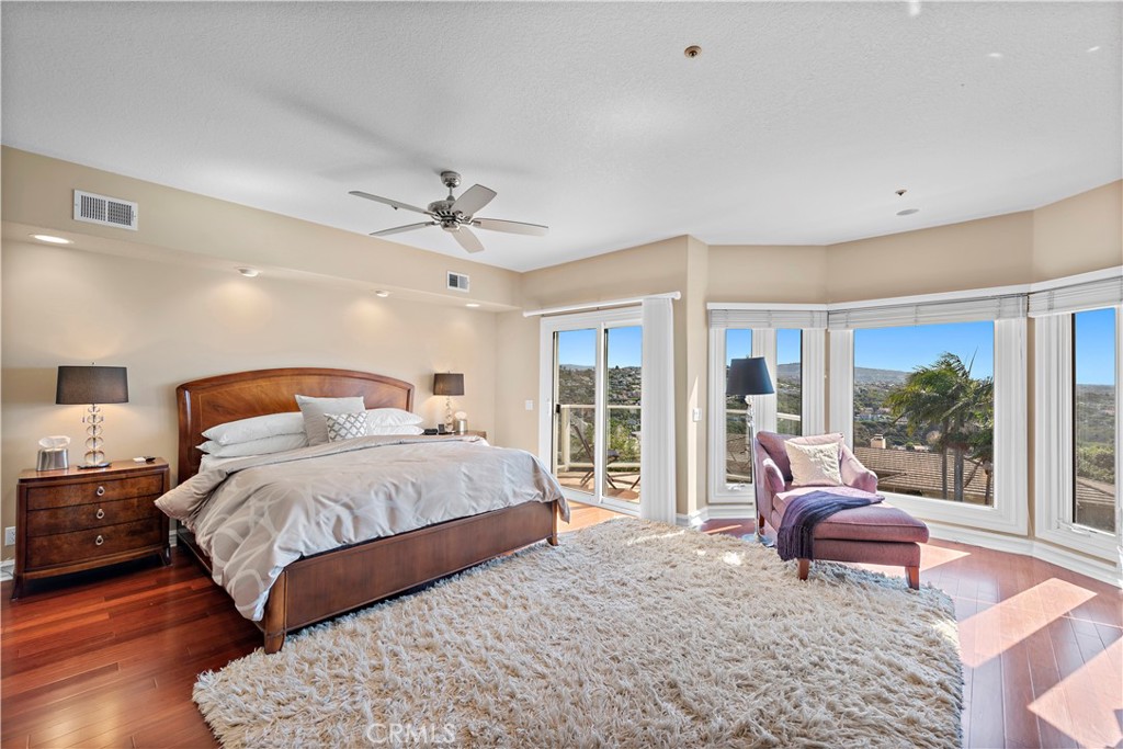 4 Via Goleta San Clemente, CA 92673 - Photo 27 of 70 a spacious bedroom with a bed and glass walk in closet