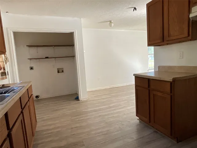 a room with wooden floor and cabinets