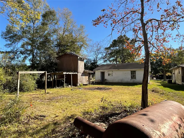 a view of a patio with a table and chairs next to a yard