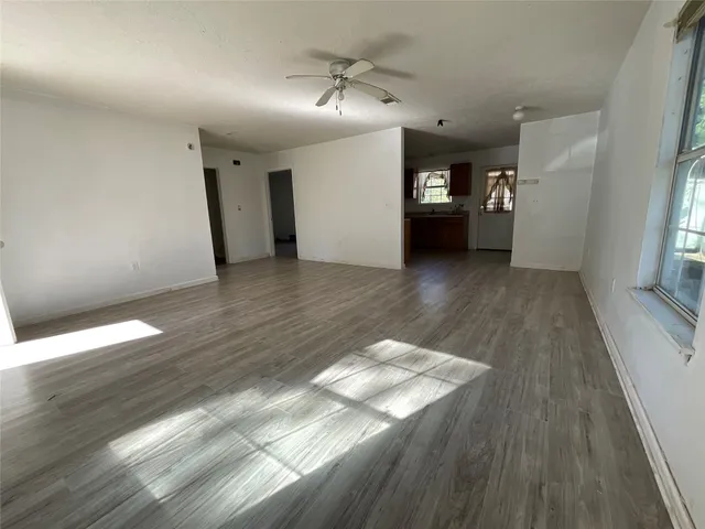 wooden floor in an empty room with a window