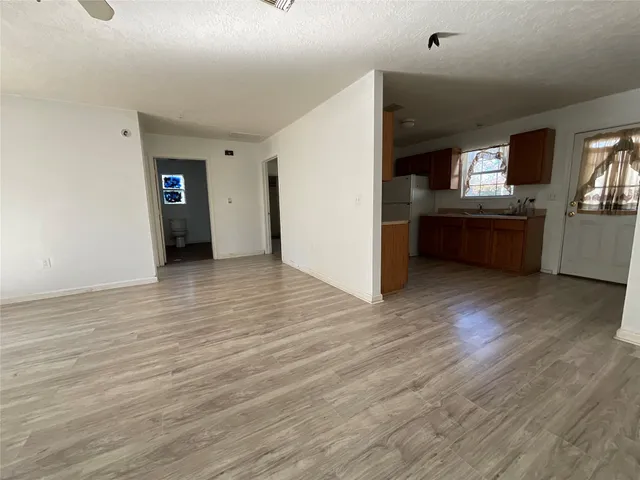 a view of a kitchen with a sink and a refrigerator