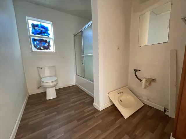 a bathroom with a toilet sink and mirror