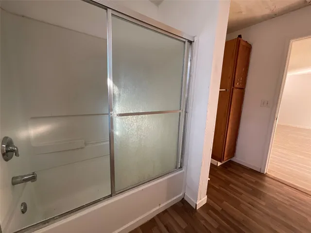 a bathroom with a glass shower door
