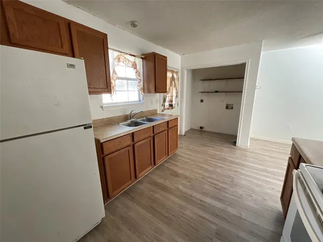 a kitchen with a refrigerator a sink and a stove