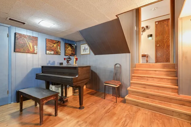 a living room with furniture and a piano