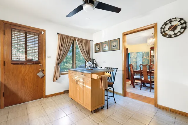 a view of a hallway with dining area and glass door
