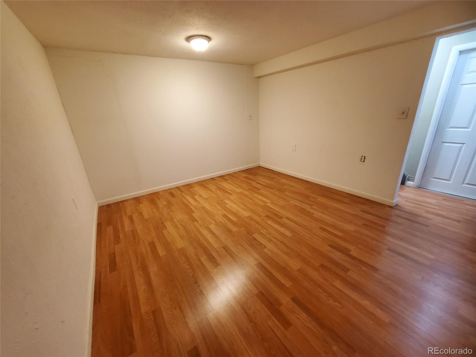 Undisclosed Address Broomfield, CO 80023 - Photo 12 of 25 a view of empty room with wooden floor