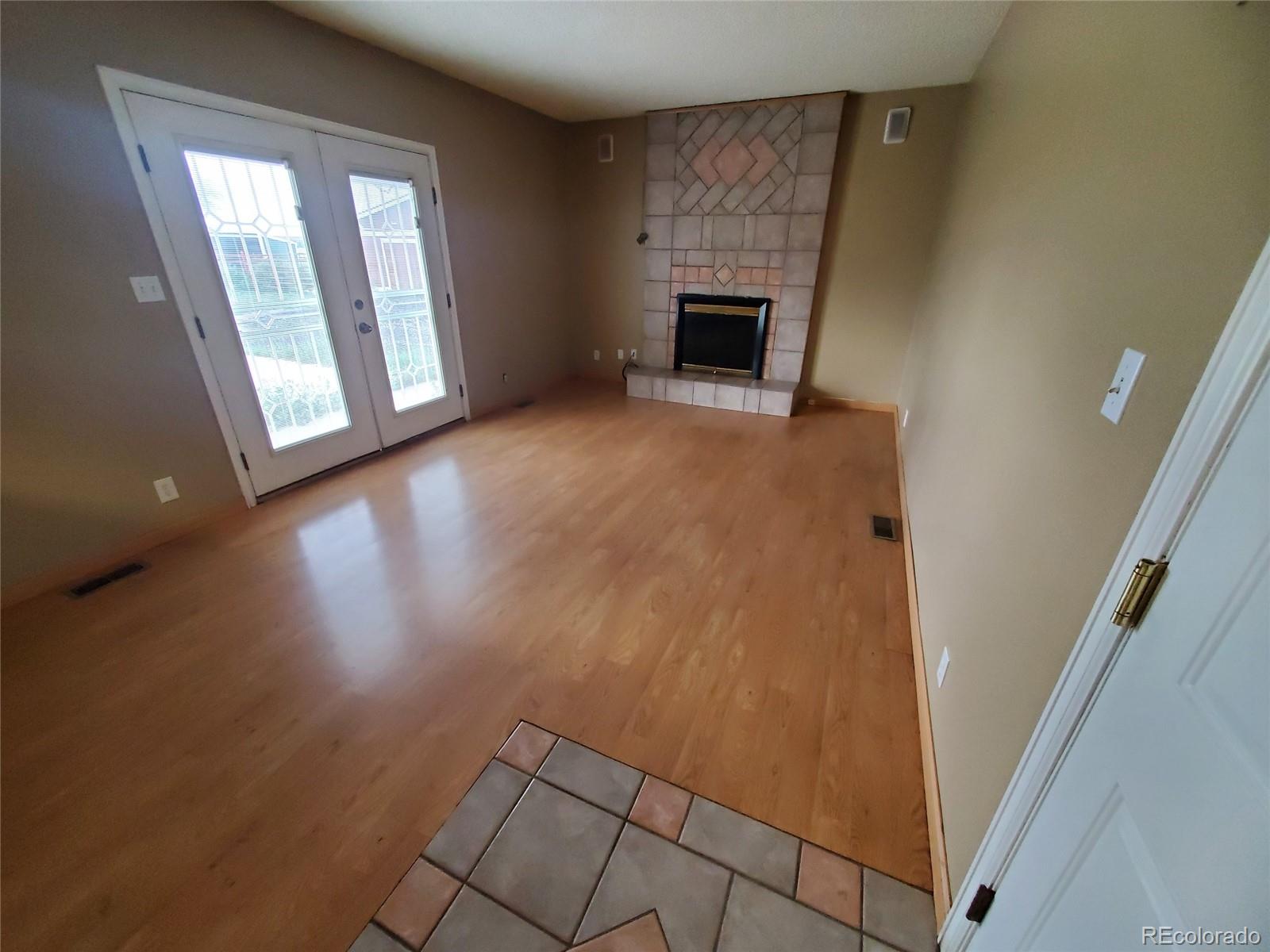 Undisclosed Address Broomfield, CO 80023 - Photo 13 of 25 a view of empty room with wooden floor and fireplace
