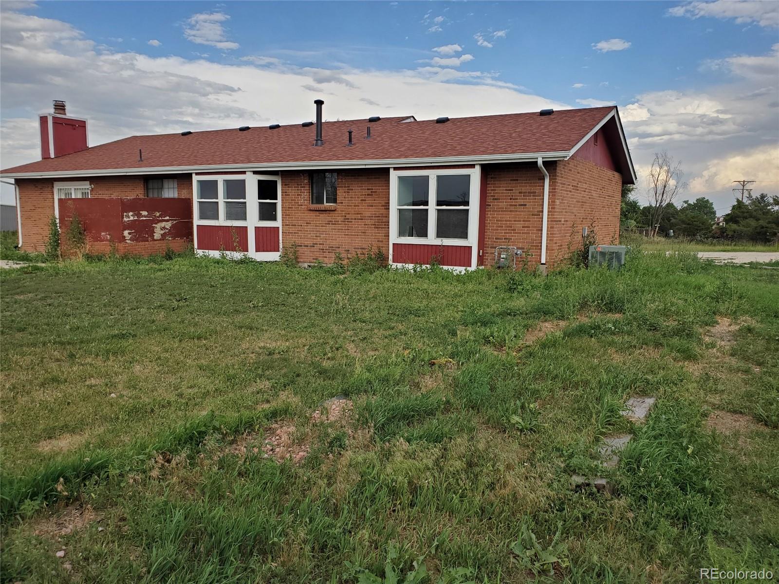 Undisclosed Address Broomfield, CO 80023 - Photo 2 of 25 a front view of a house with a garden