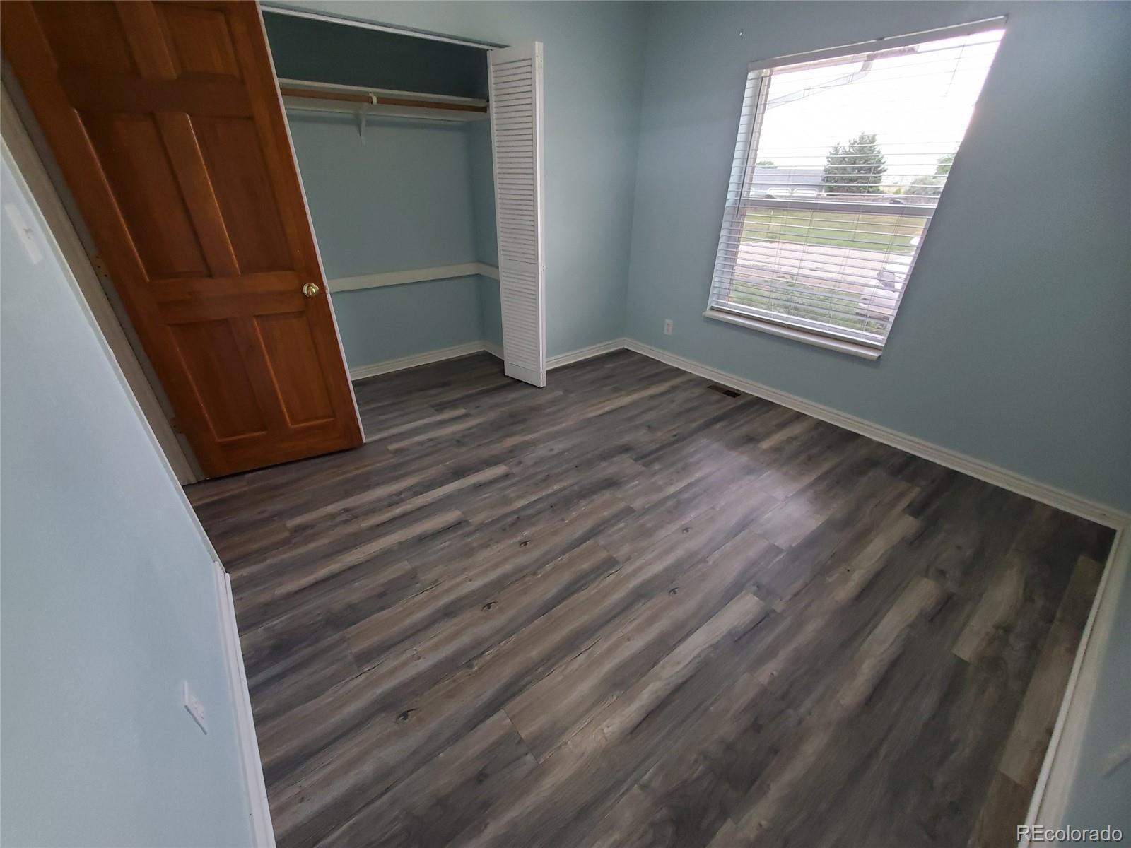 Undisclosed Address Broomfield, CO 80023 - Photo 7 of 25 a view of an empty room with wooden floor and a window