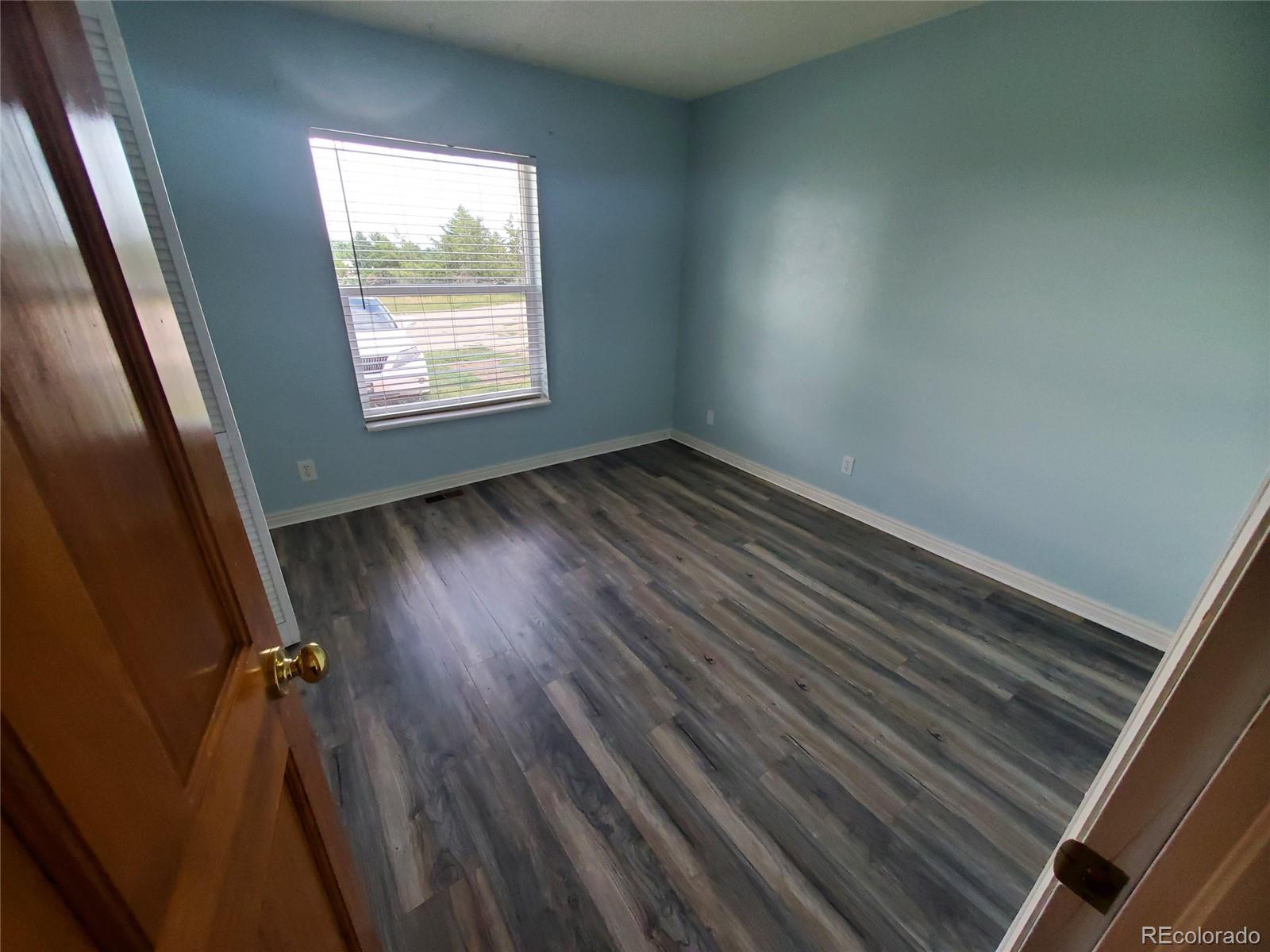 Undisclosed Address Broomfield, CO 80023 - Photo 8 of 25 an empty room with wooden floor and windows