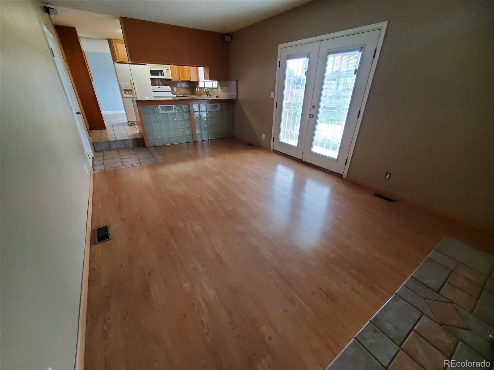 Undisclosed Address Broomfield, CO 80023 - Photo 9 of 25 an empty room with kitchen and windows