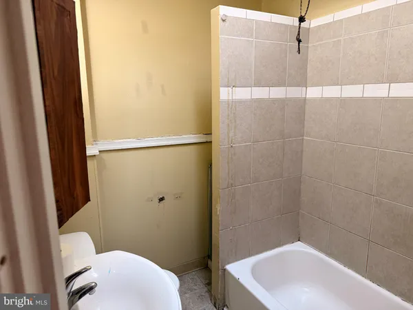 a bathroom with a sink a toilet a shower and a mirror