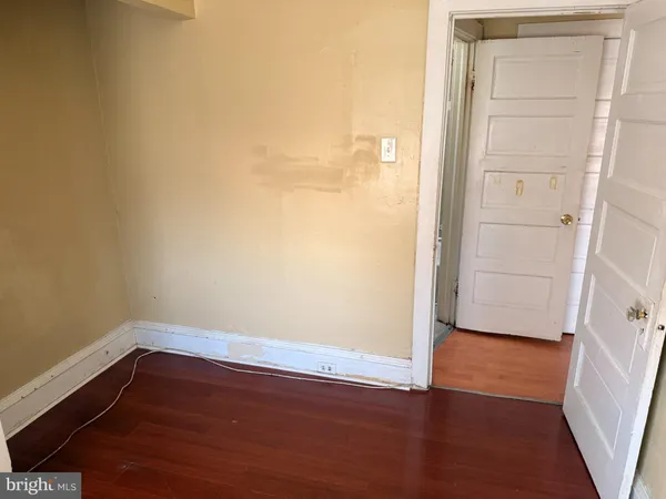 a view of a small space with wooden floor and a window